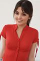 A woman in a red dress posing for a picture.